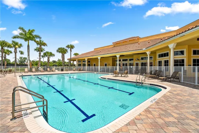 a view of a swimming pool with outdoor seating