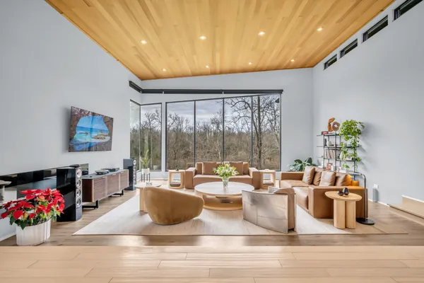a living room with furniture and a wall painting