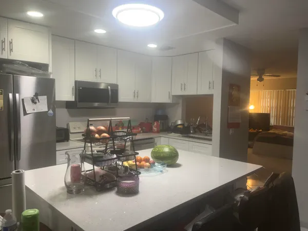 a kitchen with a sink a stove and chairs