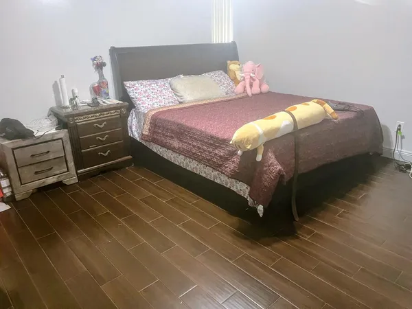 a bedroom with a bed and a tv