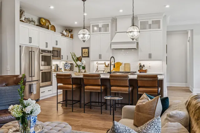 a dining room with furniture potted plants and wooden floor