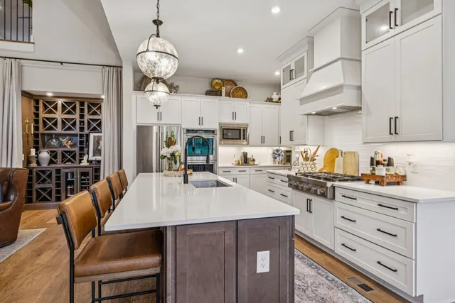 a kitchen with stainless steel appliances a refrigerator and a sink