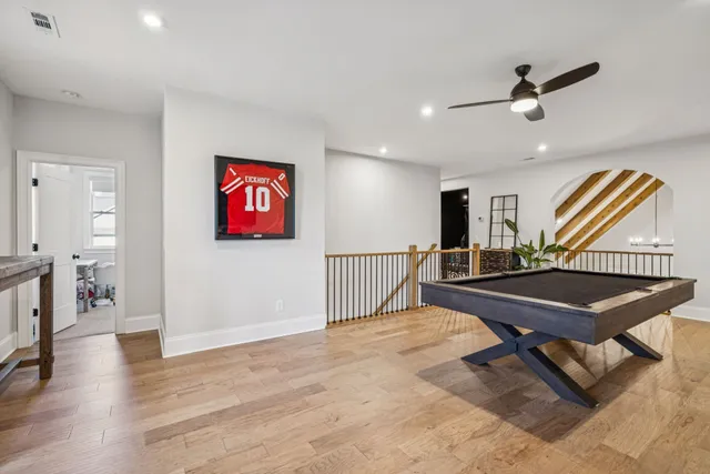 an aerial view of a house with a garden and lake view