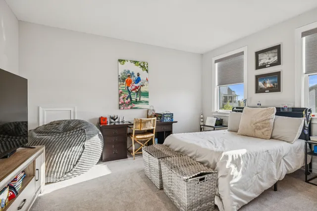 an aerial view of a house with swimming pool and large trees