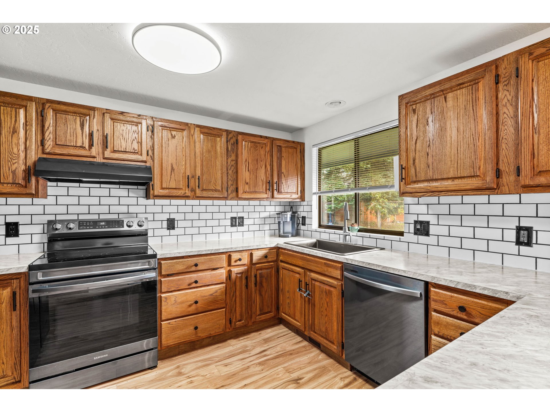 289 73rd Place Springfield, OR 97478 - Photo 15 of 32 a kitchen with stainless steel appliances granite countertop a sink stove and oven