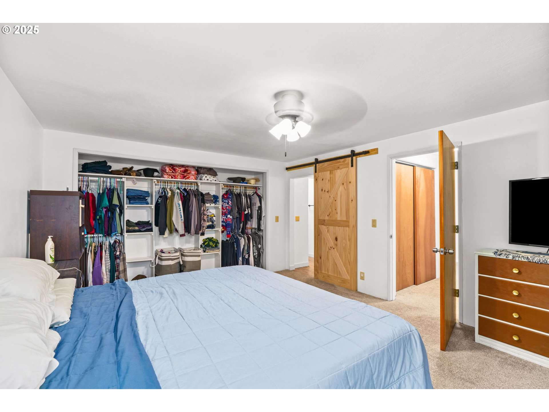 289 73rd Place Springfield, OR 97478 - Photo 23 of 32 a bedroom with a bed and a flat tv screen on dresser
