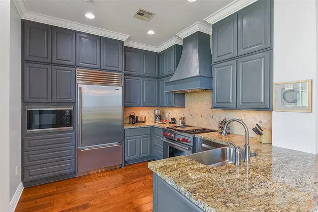a bathroom with a granite countertop sink a mirror and a shower