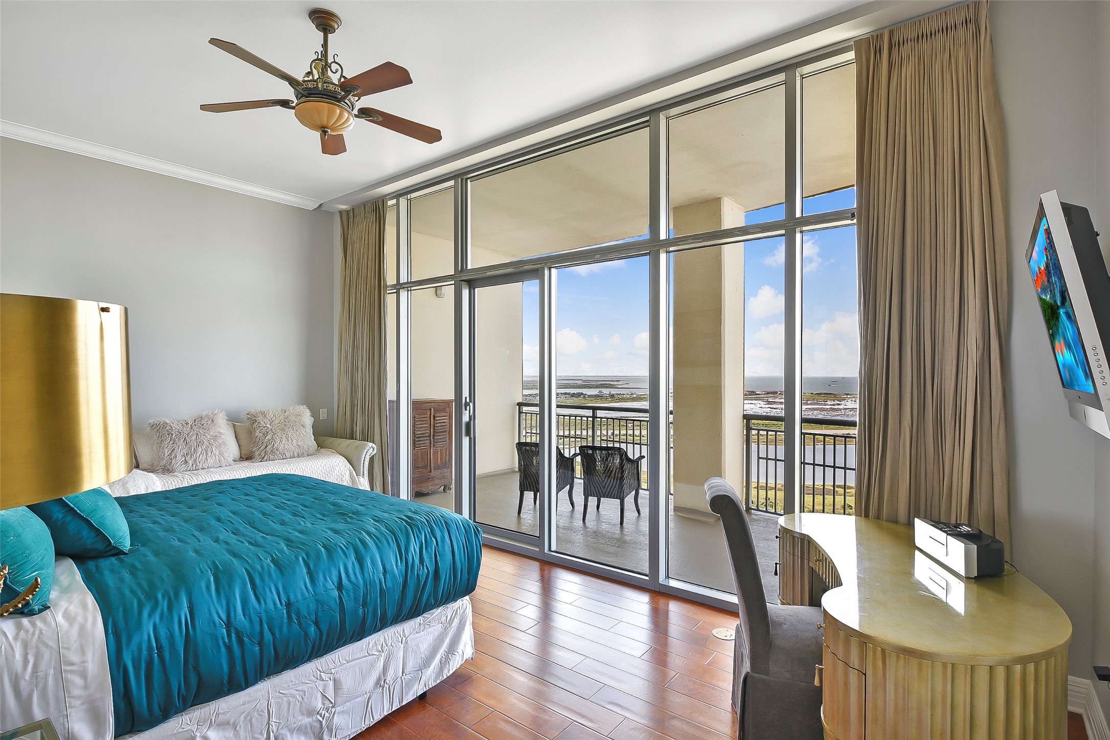 801 East Beach Drive, Unit TW2704 Galveston, TX 77550 - Photo 40 of 48 a bedroom with a bed and a large window with wooden floor