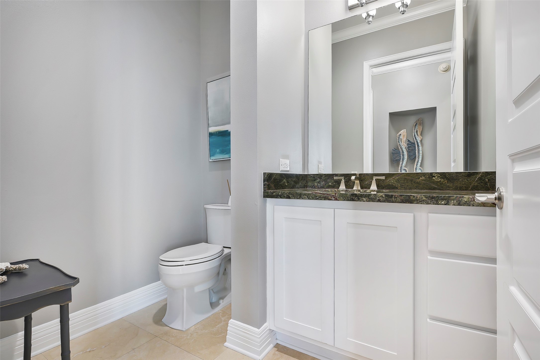 801 East Beach Drive, Unit TW2704 Galveston, TX 77550 - Photo 6 of 48 a bathroom with a toilet sink and mirror