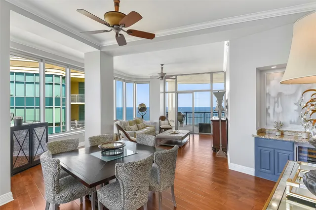 a living room with furniture a flat screen tv and a large window