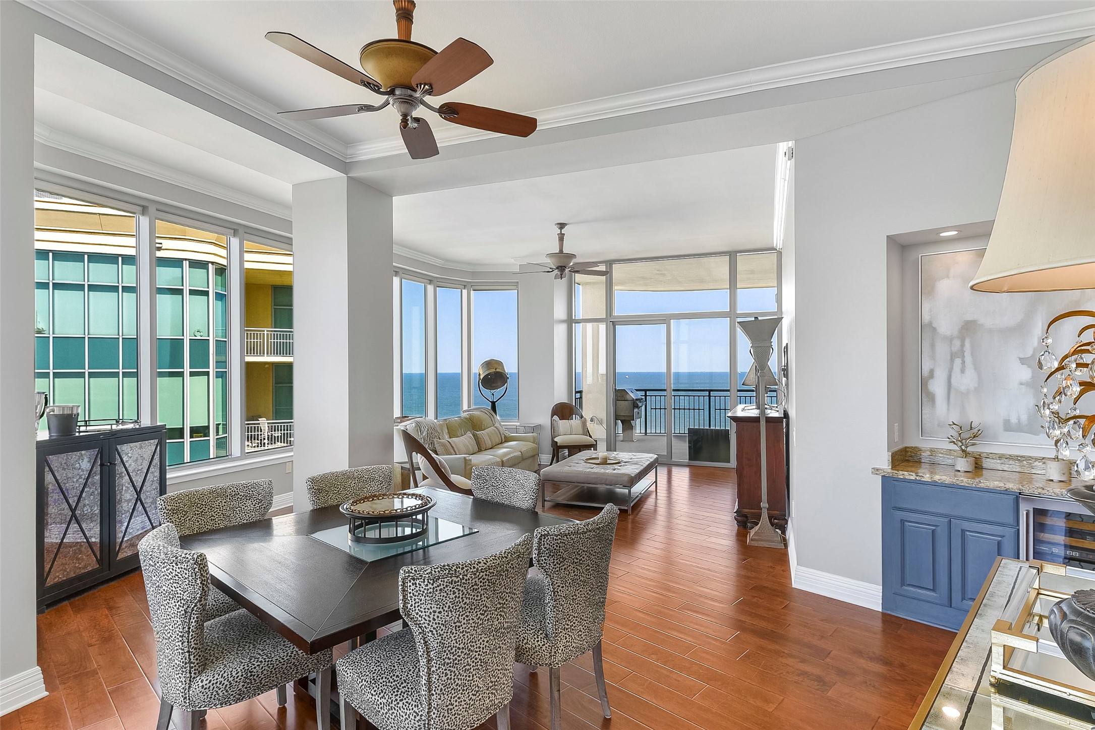 801 East Beach Drive, Unit TW2704 Galveston, TX 77550 - Photo 8 of 48 a living room with couches a fireplace and a dining table with wooden floor
