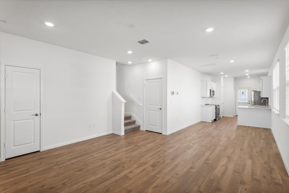 2620 Caleb Asher Loop Round Rock, TX 78665 - Photo 15 of 40 a view of a big room with wooden floor and a kitchen