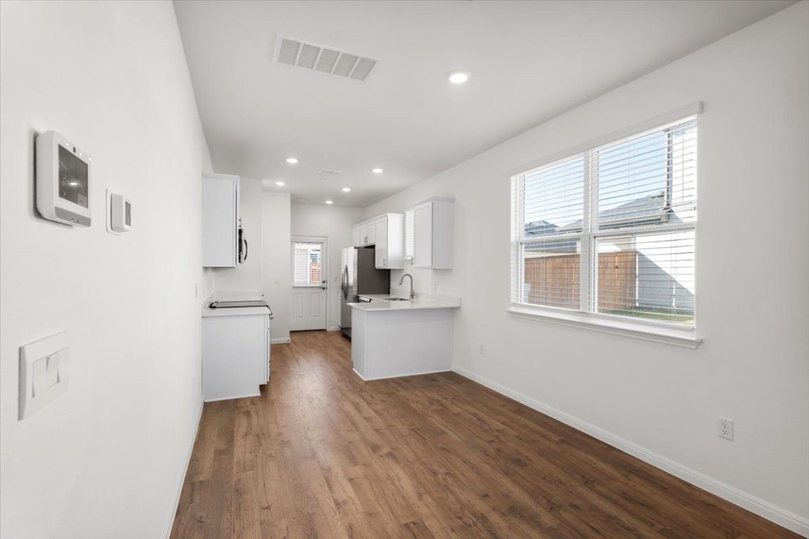 2620 Caleb Asher Loop Round Rock, TX 78665 - Photo 18 of 40 a kitchen with a refrigerator and white cabinets