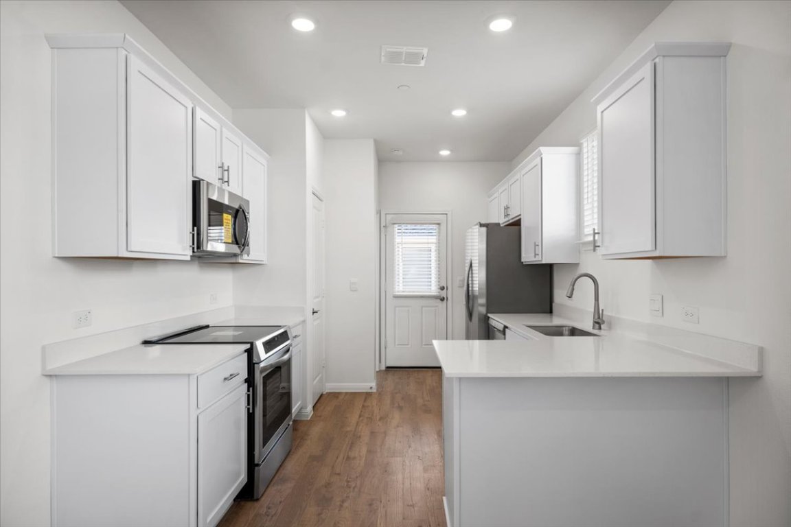 2620 Caleb Asher Loop Round Rock, TX 78665 - Photo 19 of 40 a kitchen with white cabinets sink and stainless steel appliances