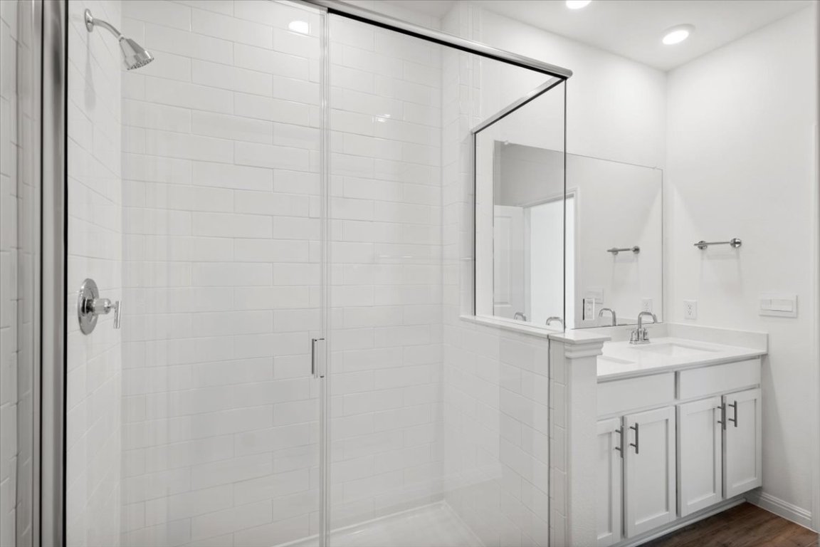 2620 Caleb Asher Loop Round Rock, TX 78665 - Photo 25 of 40 a bathroom with a granite countertop sink a mirror and shower