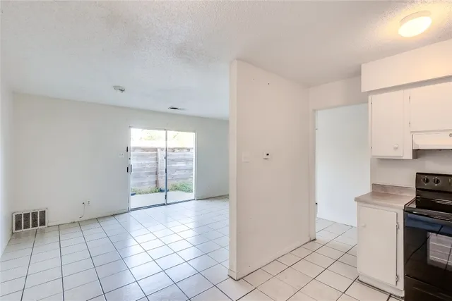 a view of a kitchen with a stove top oven