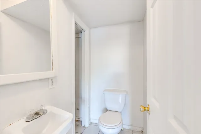 a white toilet sitting next to a bathroom sink