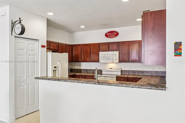 a kitchen with a stove a sink and cabinets
