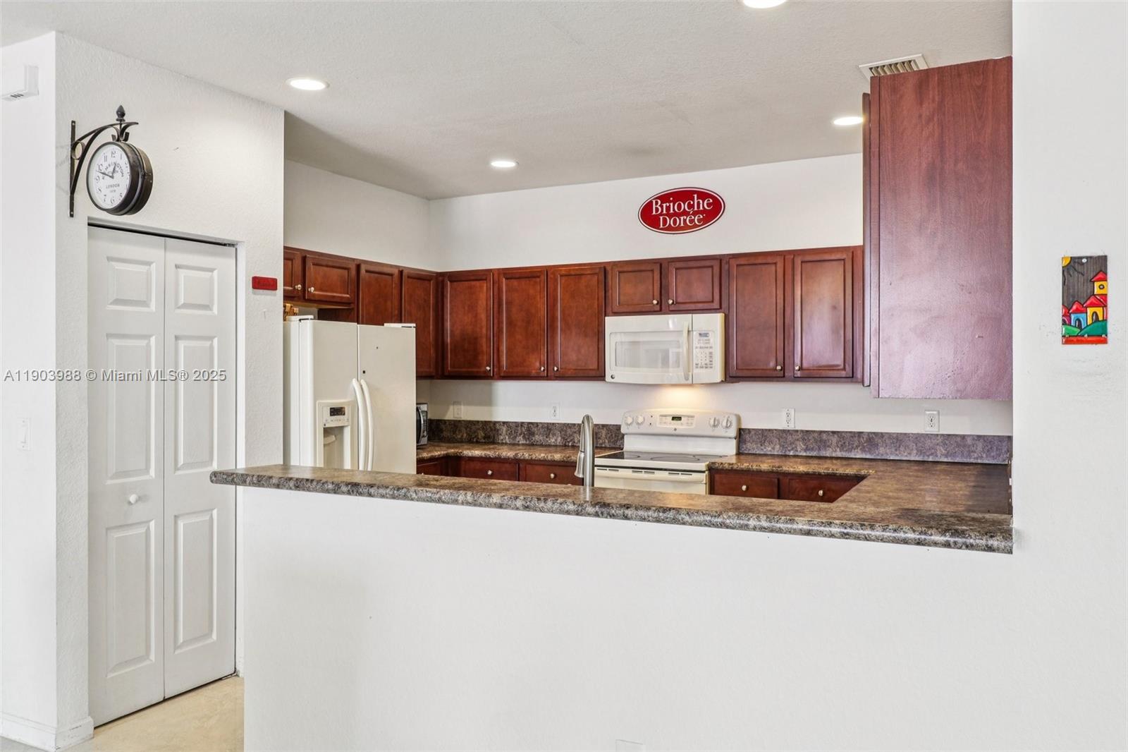 22777 Southwest 93rd Court Cutler Bay, FL 33190 - Photo 14 of 54 a kitchen with stainless steel appliances granite countertop a sink and a refrigerator