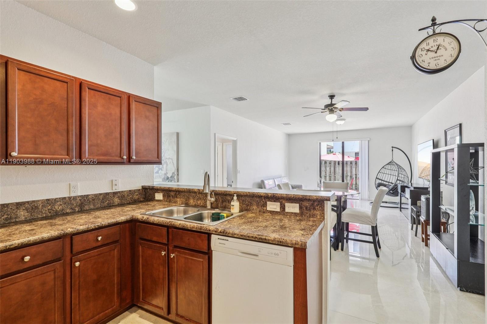 22777 Southwest 93rd Court Cutler Bay, FL 33190 - Photo 16 of 54 a kitchen with a stove a sink and cabinets