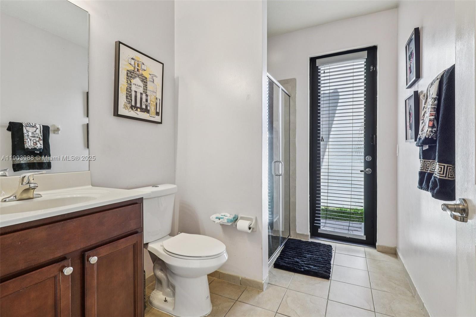 22777 Southwest 93rd Court Cutler Bay, FL 33190 - Photo 18 of 54 a bathroom with a toilet a sink and mirror