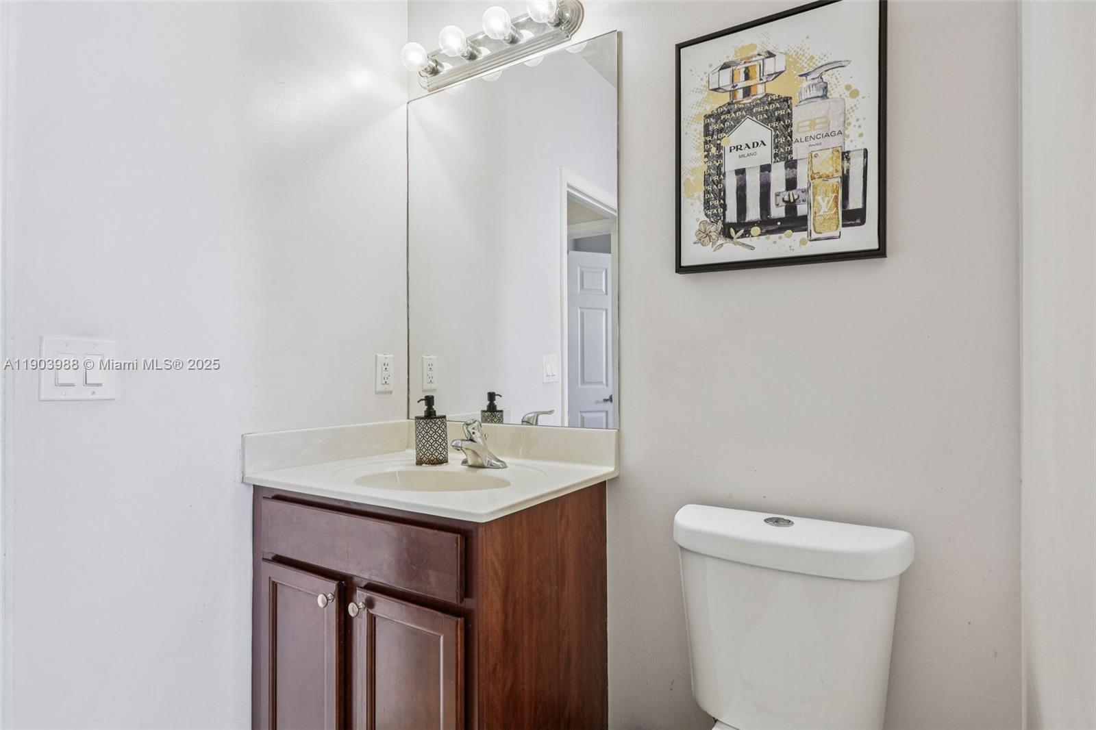22777 Southwest 93rd Court Cutler Bay, FL 33190 - Photo 20 of 54 a bathroom with a toilet a sink and mirror