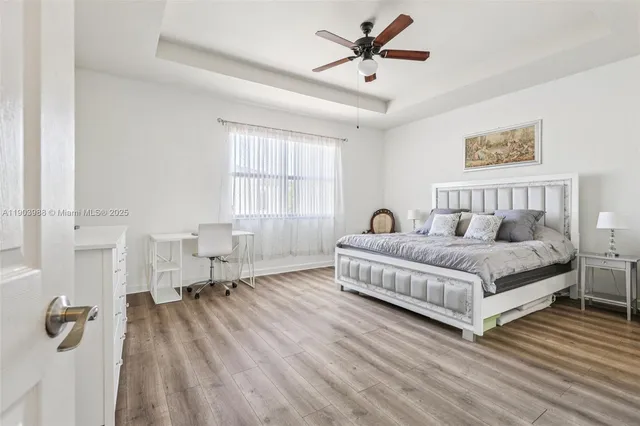 a bedroom with a large bed and a lamp on table