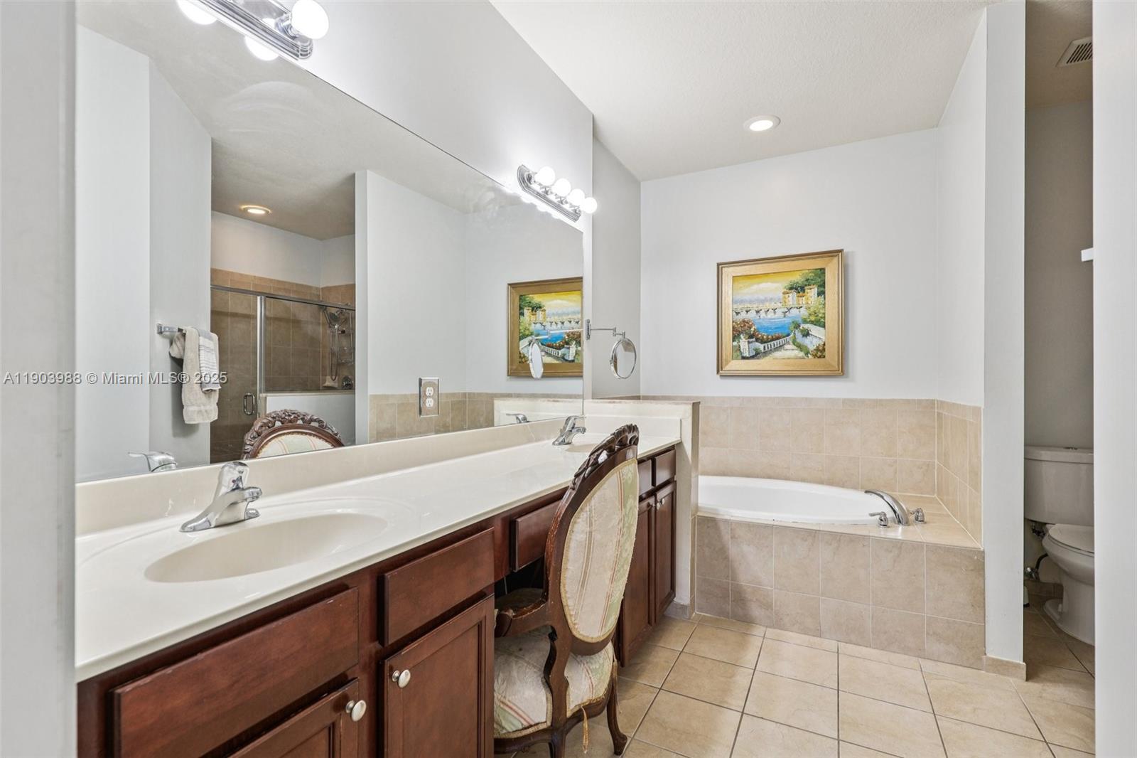 22777 Southwest 93rd Court Cutler Bay, FL 33190 - Photo 28 of 54 a bathroom with a tub a sink and a mirror