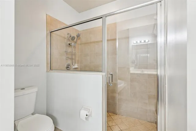 a bathroom with a double vanity sink a large mirror a bathtub and shower