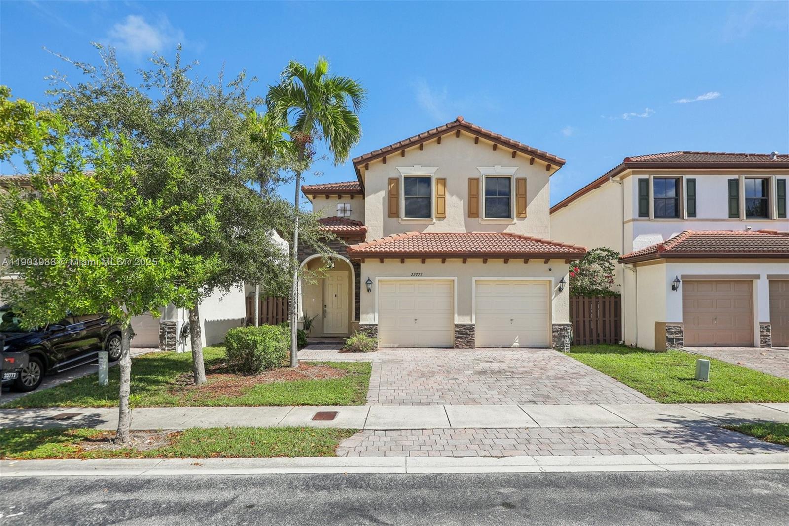 22777 Southwest 93rd Court Cutler Bay, FL 33190 - Photo 3 of 54 a front view of a house with a yard and garage