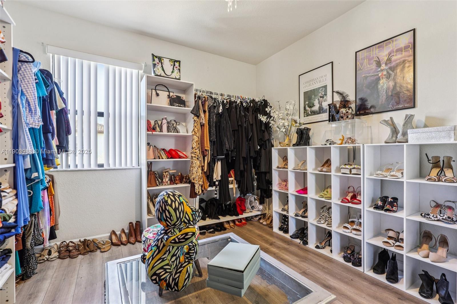 22777 Southwest 93rd Court Cutler Bay, FL 33190 - Photo 31 of 54 a view of walk in closet with clothes and shoes