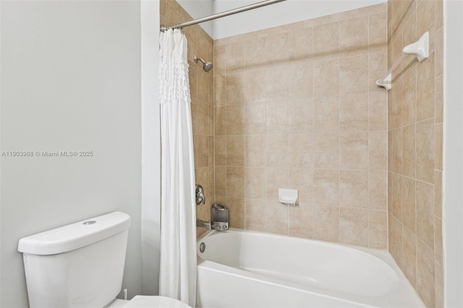 22777 Southwest 93rd Court Cutler Bay, FL 33190 - Photo 33 of 54 a white bath tub sitting next to a toilet