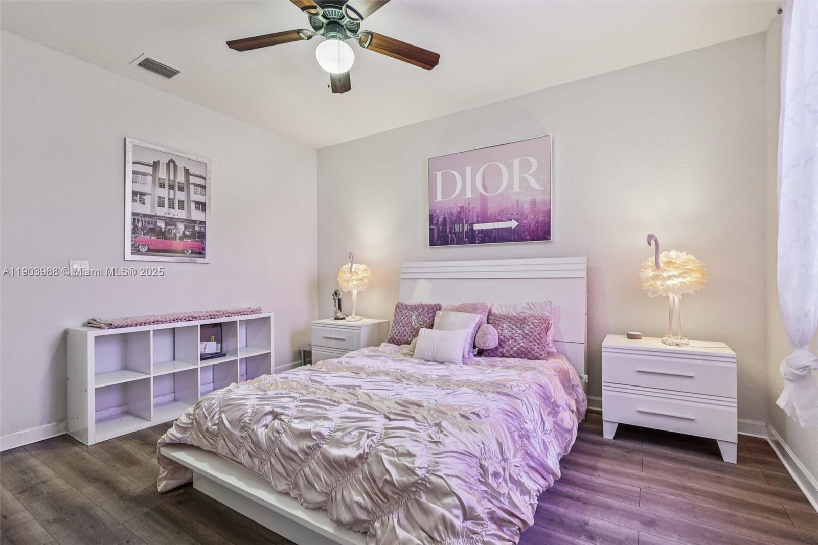 22777 Southwest 93rd Court Cutler Bay, FL 33190 - Photo 37 of 54 a bedroom with a bed and a chandelier