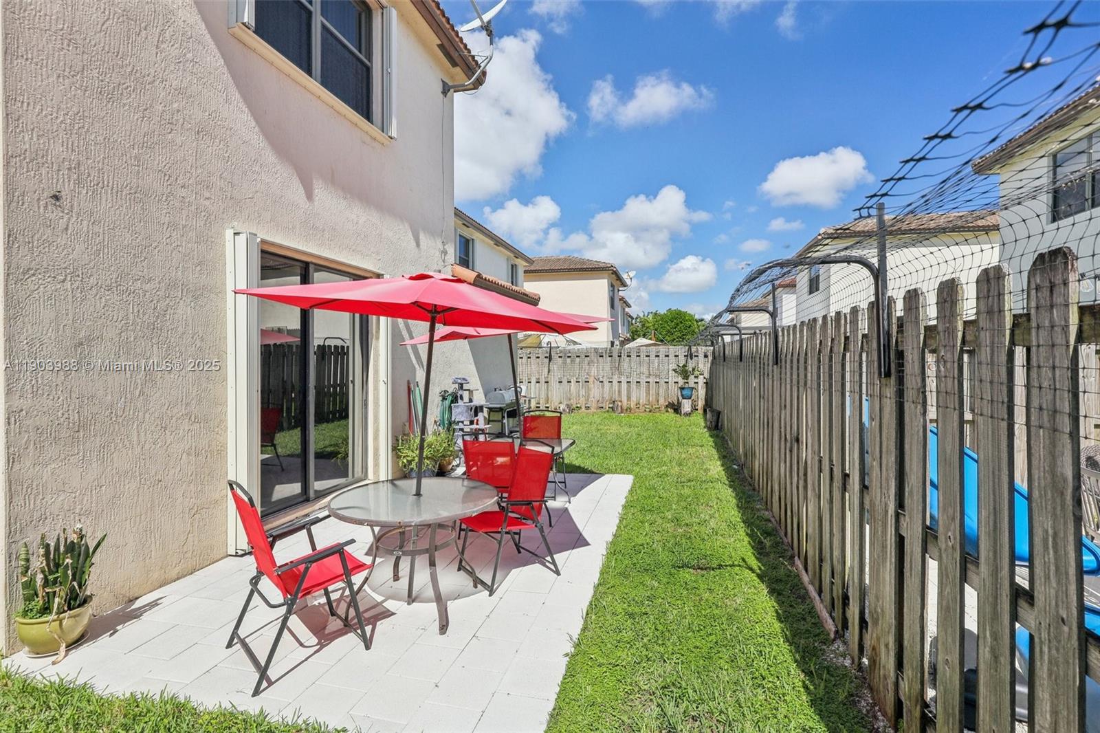 22777 Southwest 93rd Court Cutler Bay, FL 33190 - Photo 43 of 54 a view of a patio with a table and chairs