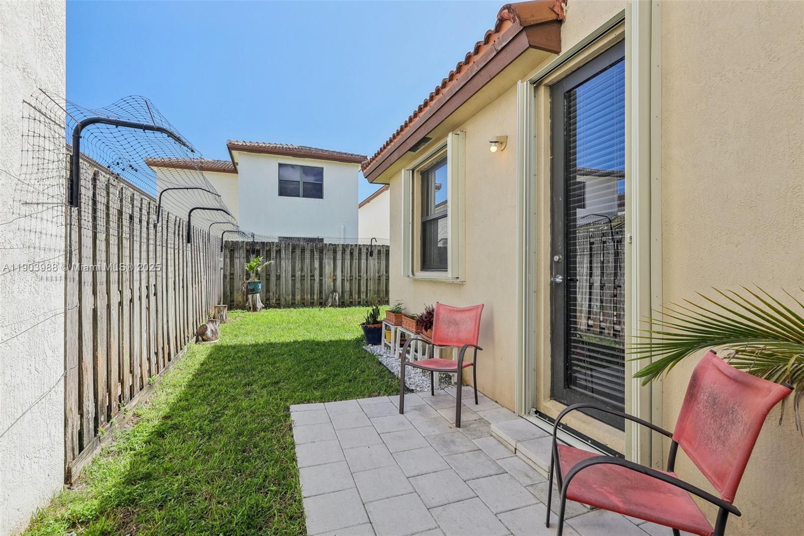 22777 Southwest 93rd Court Cutler Bay, FL 33190 - Photo 46 of 54 a porch with a bench next to a yard