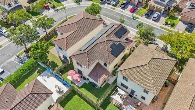 an aerial view of residential houses with outdoor space and river