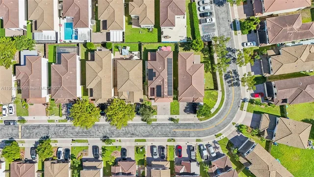 an aerial view of residential houses with outdoor space