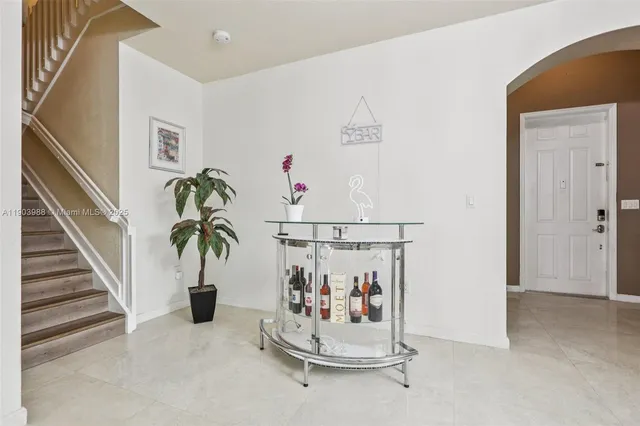 a living room with patio furniture and a chandelier