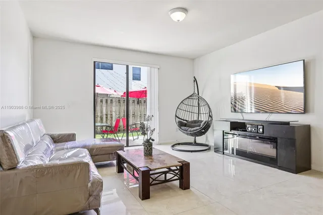a view of a livingroom with furniture and a window