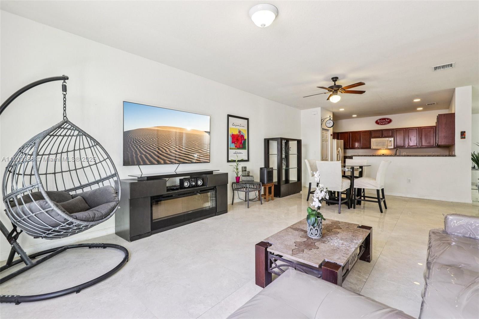 22777 Southwest 93rd Court Cutler Bay, FL 33190 - Photo 9 of 54 a living room with furniture and a chandelier