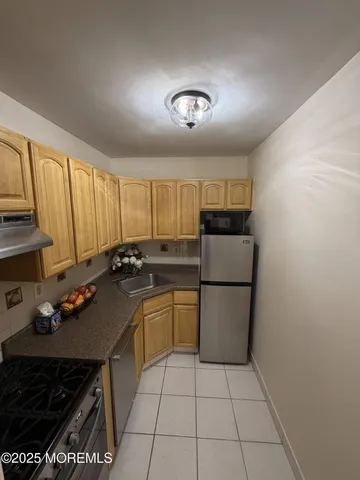 a kitchen with a sink a stove and refrigerator