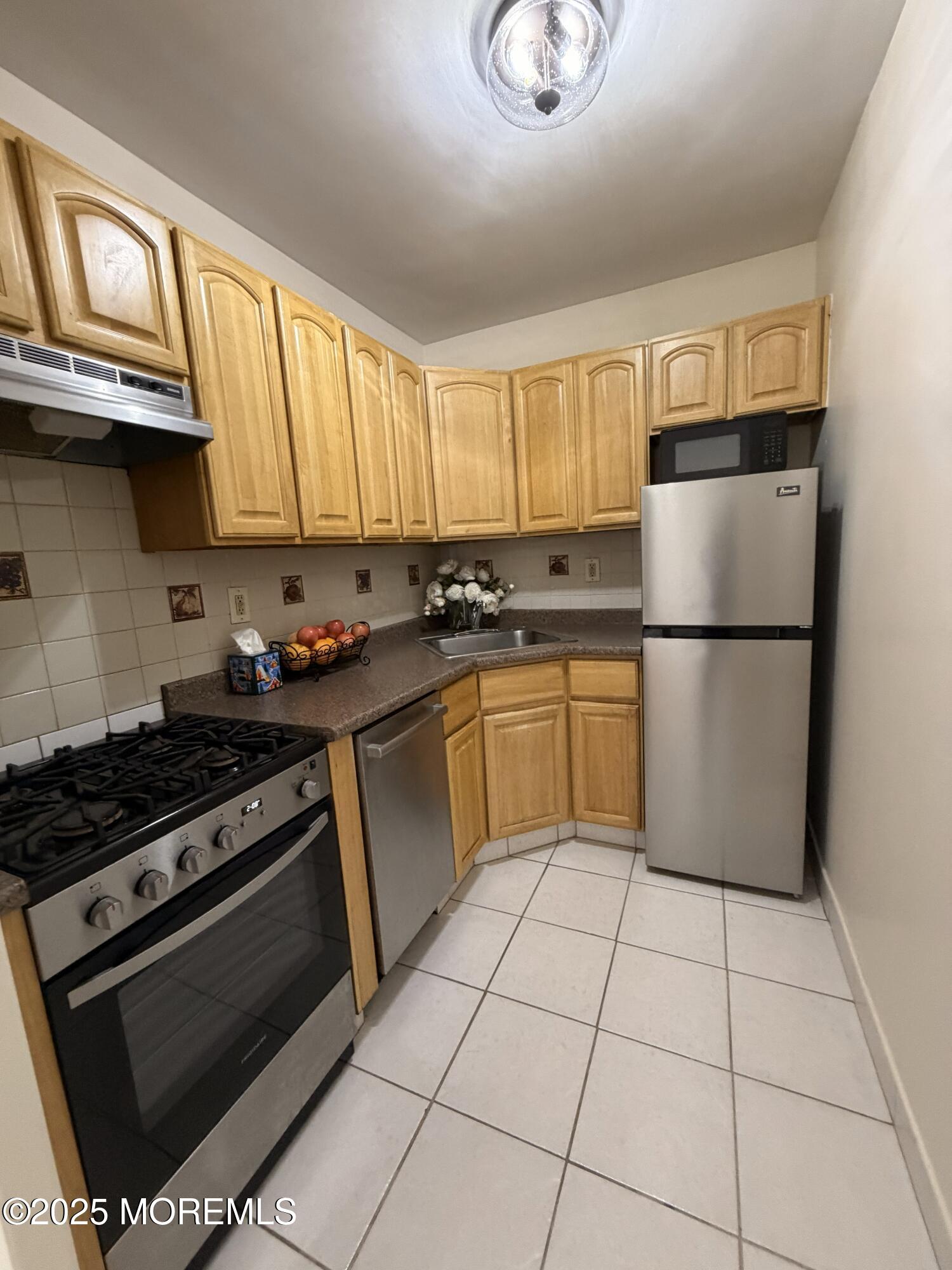 1225 John F. Kennedy Boulevard, Unit 8I Bayonne, NJ 07002 - Photo 12 of 18 a kitchen with a stove a sink and a refrigerator