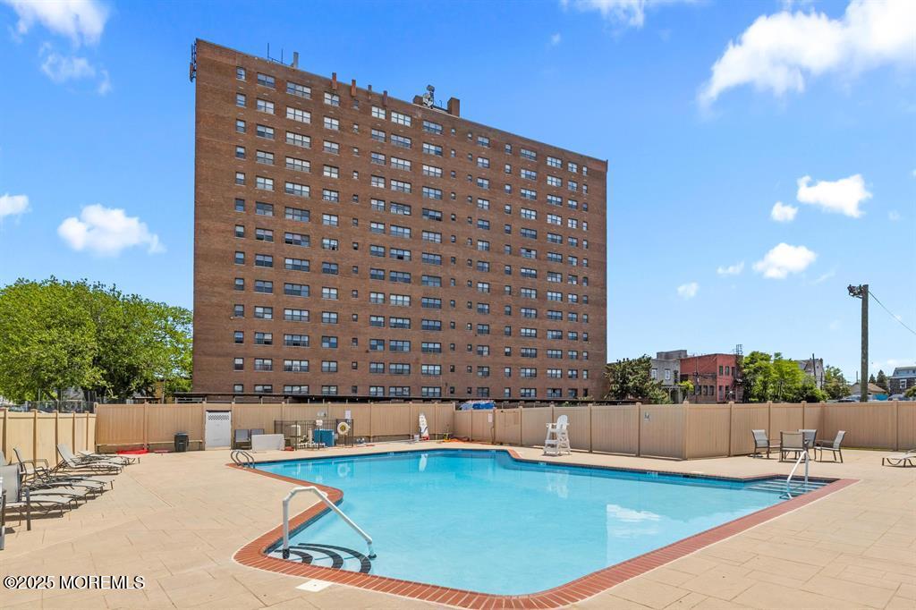 1225 John F. Kennedy Boulevard, Unit 8I Bayonne, NJ 07002 - Photo 2 of 18 a view of a swimming pool and a chairs