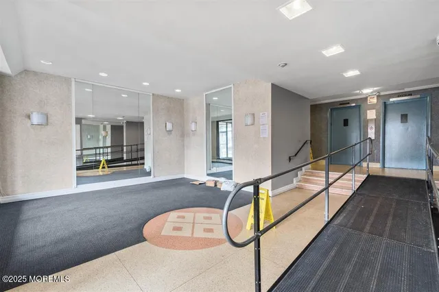 a spacious bathroom with a glass shower door and mirror