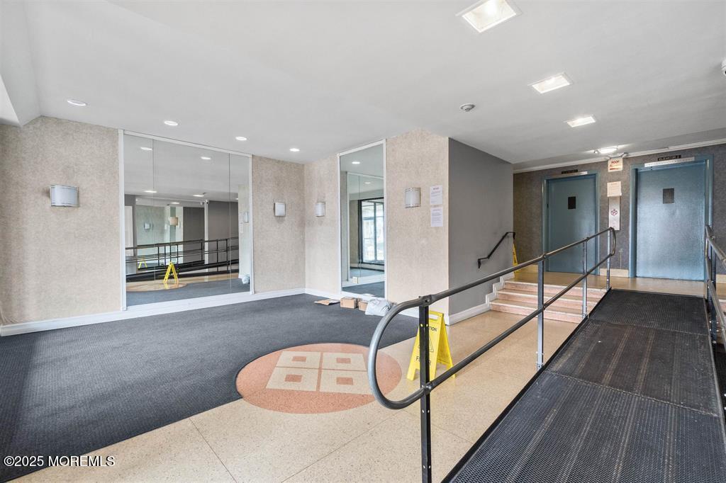 1225 John F. Kennedy Boulevard, Unit 8I Bayonne, NJ 07002 - Photo 5 of 18 a spacious bathroom with a glass shower door and mirror