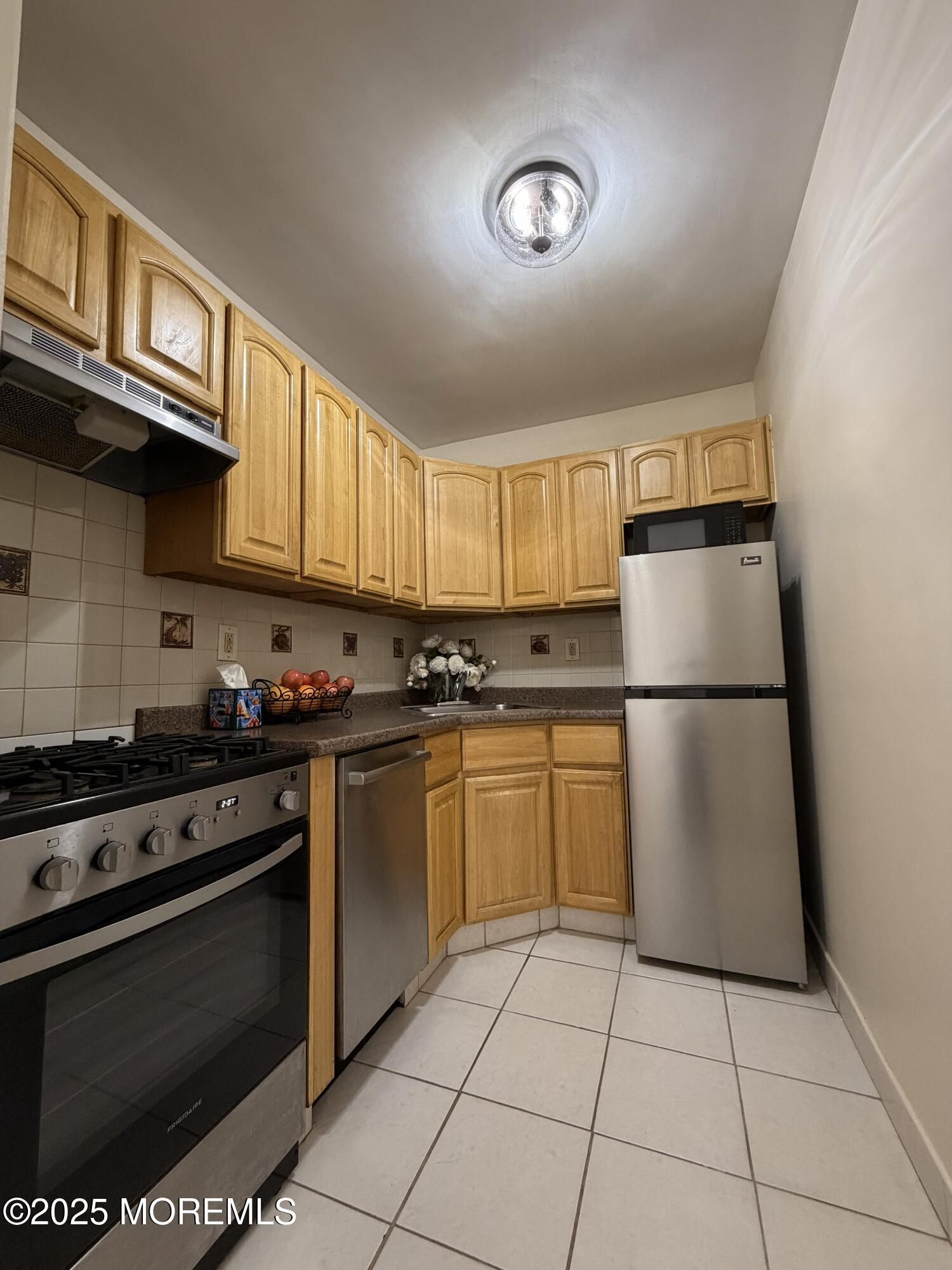 1225 John F. Kennedy Boulevard, Unit 8I Bayonne, NJ 07002 - Photo 10 of 18 a kitchen with a stove top oven cabinets and a refrigerator