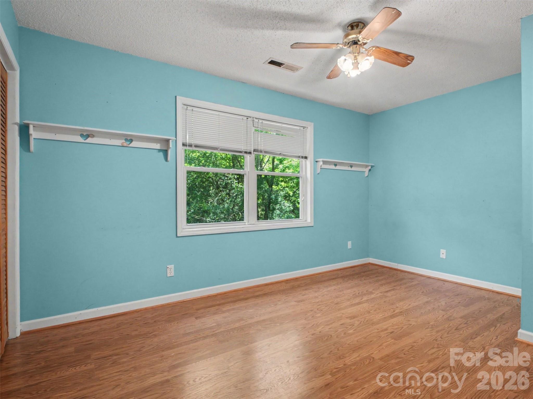 11109 Asbury Chapel Road Huntersville, NC 28078 - Photo 13 of 33 a view of an empty room with a window and a fan