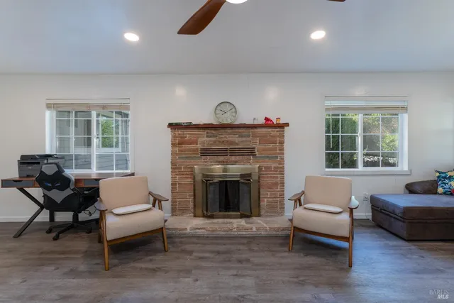 a living room with furniture a rug and a window