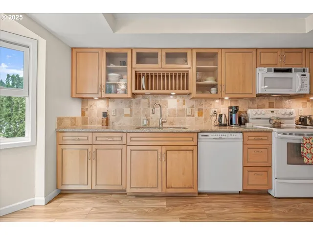 a kitchen with stainless steel appliances granite countertop a sink stove and cabinets