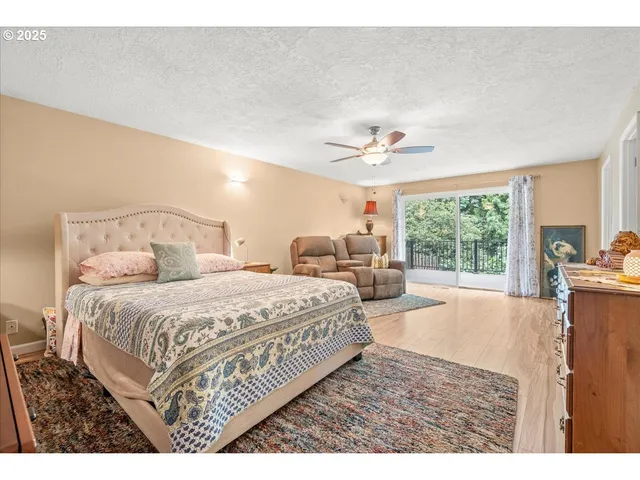 a spacious bedroom with a large bed and a chandelier
